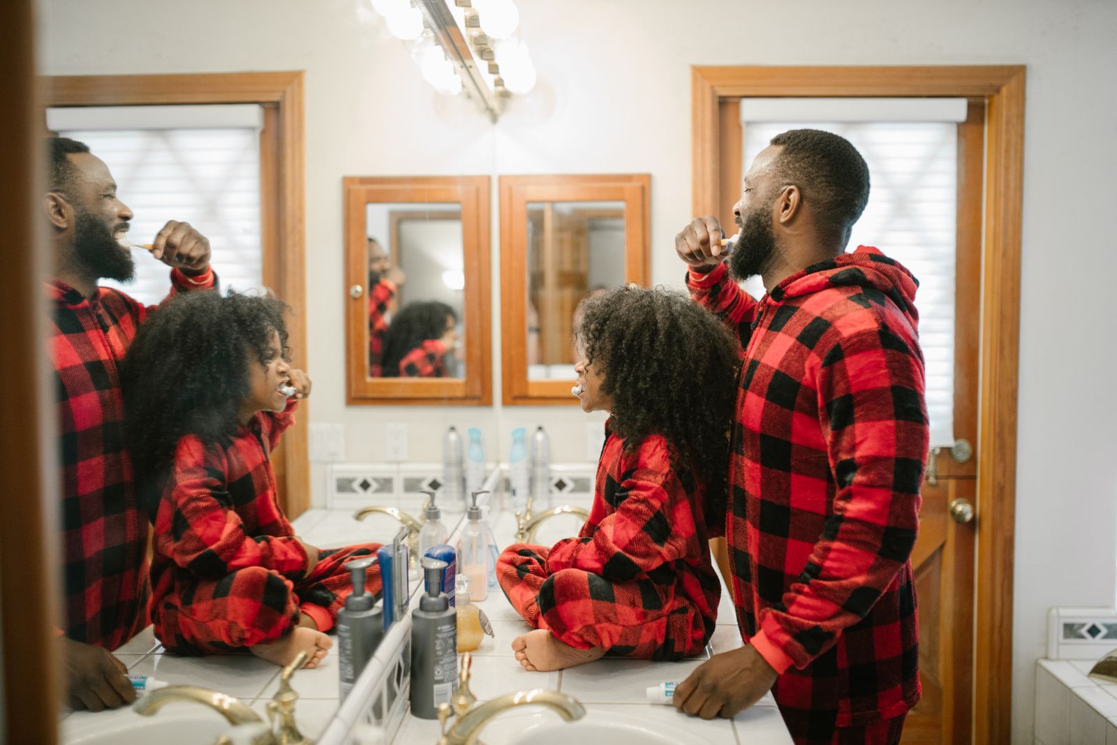 Parent and child brushing their teeth together