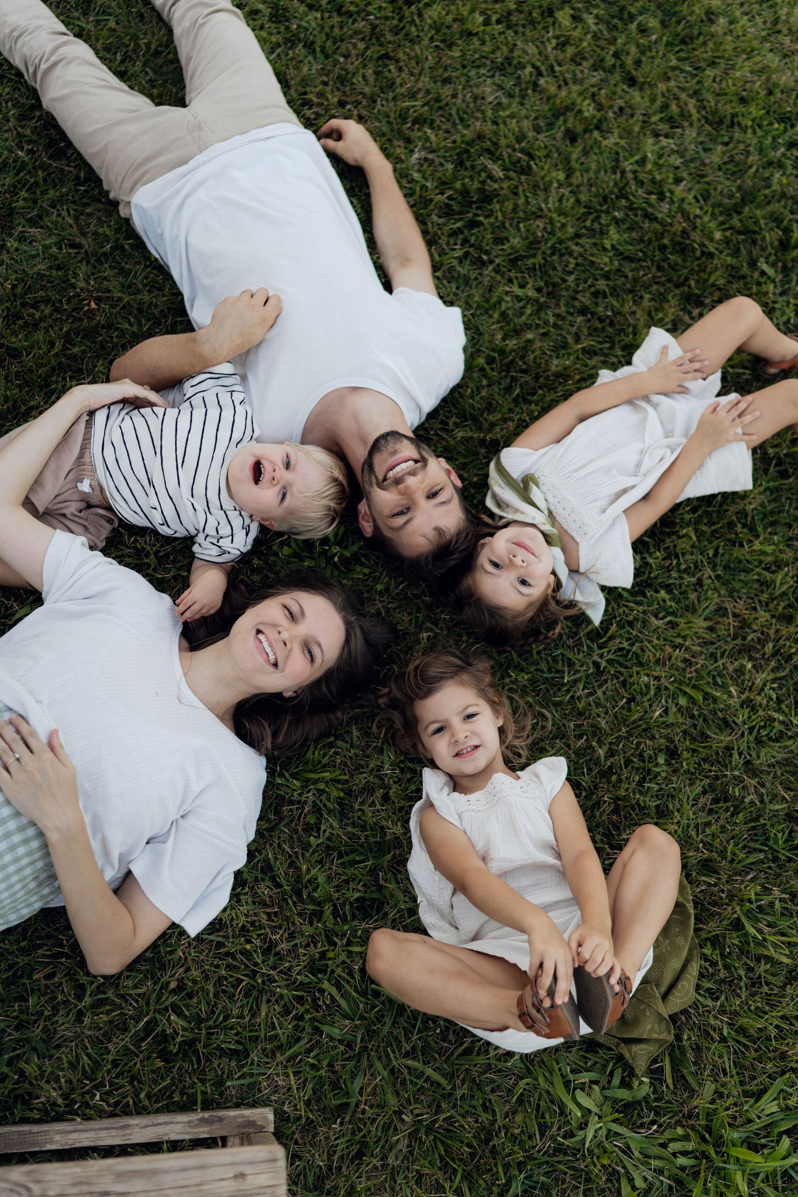 Smiling family relaxing together on the grass