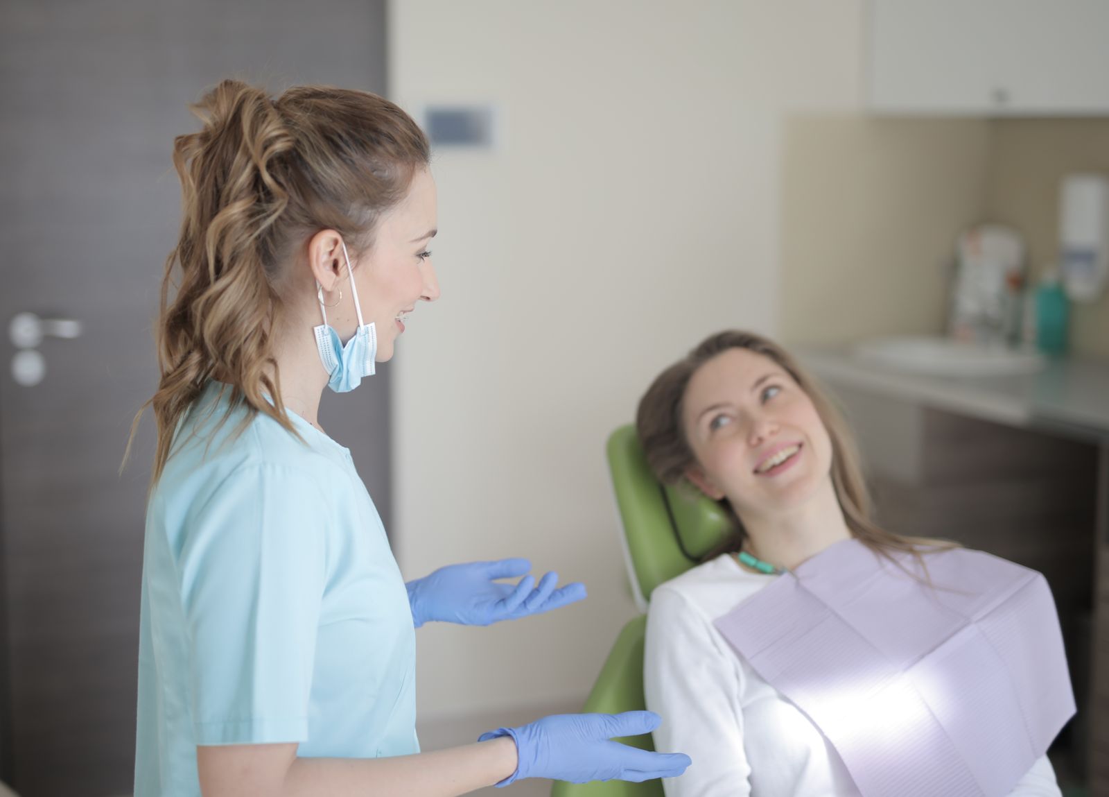 Dentist talking with a relaxed patient in the chair