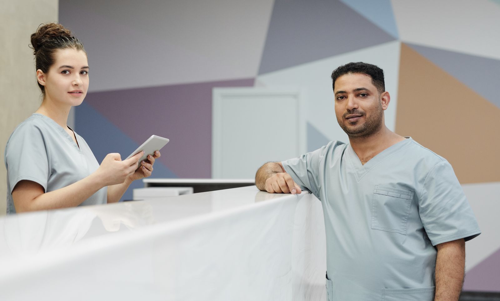 Friendly front desk team helping a patient