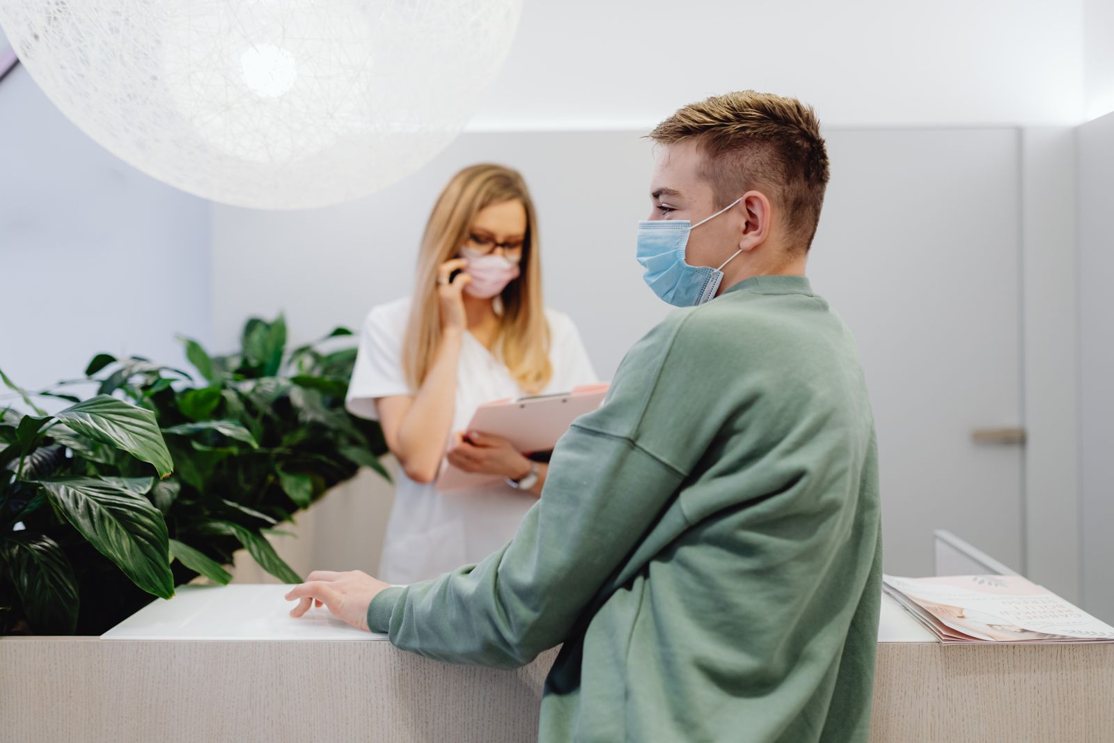 Patient checking in with a friendly receptionist