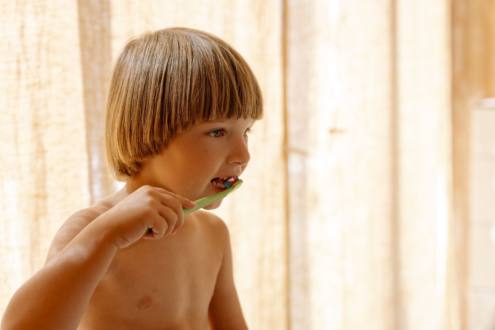 Young boy brushing his teeth